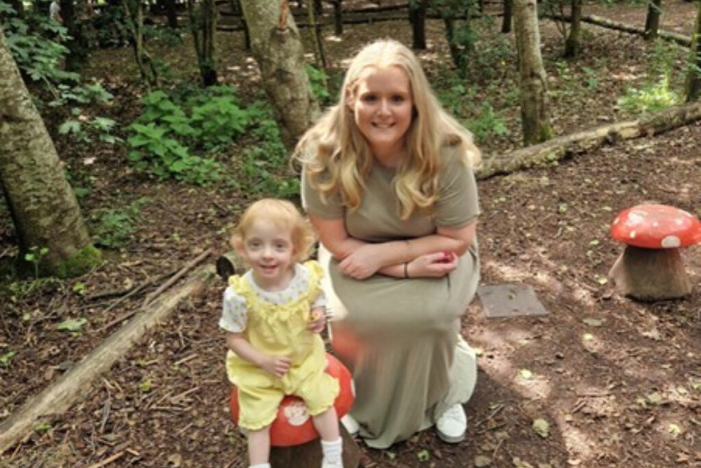 A picture of Kelly Cowcher and her daughter in a forest